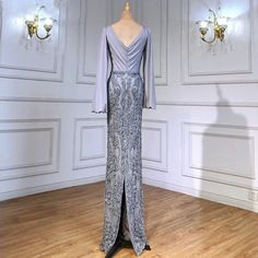 Elegant mermaid silhouette for a flattering and timeless look. Luxurious grey color exudes sophistication and elegance. Lantern sleeves adorned with intricate beadwork for added allure. Perfect for formal events and evening parties. Crafted with high-quality materials for comfort and durability. Seamlessly blends luxury with elegant design for a standout appearance. Beaded Lantern, Gown Elegant, Sleeve For Women, Mermaid Silhouette, Mermaid Evening Dresses, Dress Gown, Women Party, Lantern Sleeve, Lantern Sleeves