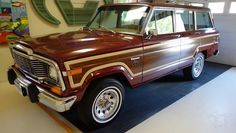 an old station wagon is on display in a museum exhibit room with other cars and memorabilia