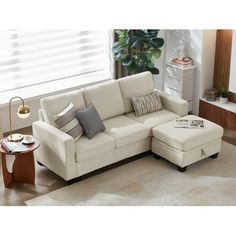 a living room scene with focus on the sectional sofa and footstool in the middle