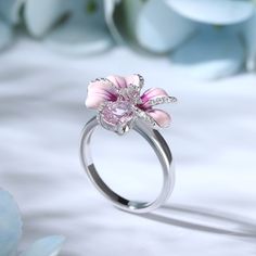 Turn up the flower power with this pink flower ring. Crafted in sterling silver, features every petals hand-painted in rich enamel, decorated with white stones, making every flower completely unique. An organically shaped band mimics a real stem and evokes the freedom of spring. Wear yours as a reminder of all the loved ones in your life.Carat Weight: 2.31 ctStone Shape: Oval, RoundStone Size: 6*8,1,1.2 mmNumber of Stones: 30 Stone Color: Diamond WhiteWeight: 4.3 gWidth: 2.4 mmHeight: 9 mmThickn Pink Silver Jewelry, Pink Enamel Rings For Gift, Pink Enamel Anniversary Ring, Pink Enamel Flower-shaped Jewelry, Pink Enamel Ring As A Gift, Pink Enamel Promise Ring, Pretty Silver Rings, Fine Jewelry Pink Flower Shaped Jewelry, Pink Diamond Flower Shaped Ring