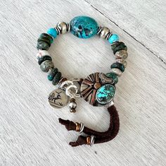 "Chunky boho bracelet, Turquoise, Jasper with Artisan Silver Button and Charm. Artisan Silver Button featuring Genuine Bao Canyon Turquoise,  Artisan Silver Charm,  Karen Hill Tribe fine silver beads, Copper beads, Bao Canton Turquoise Focal bead, Turquoise flat beads about 12 mm diameter Irregular shape natural Jasper beads about 11 mm diameter. This bracelet will fit perfect 6.5\" wrist but could be adjusted to bigger sizes with the help of a sliding silver bead placed on leather tassels." Flat Beads, Wrist Candy, Hill Tribe Silver, Silver Button, Boho Bracelet, Jasper Beads, Leather Bracelets, Silver Buttons, Silver Bead