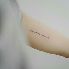 a woman's arm with an inscription on it that says, you only live once