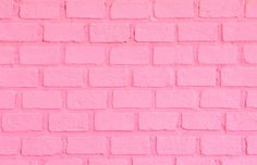 a pink brick wall that has been painted