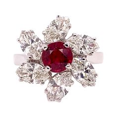 This stunning GIA certified heated ruby is the focal point in this mesmerizing custom setting in 18k white gold. The large marquis diamonds weighs 2.75 carats and surround the ruby like a pinwheel motif. The ruby is 1.14 carat and has a deep, vivid red hue. Ring Size: 6.5 & can be sized. Heart Diamond, Gemstones Jewelry, Marquise Diamond, Ruby Ring, Gold Floral, Diamond Heart, Cocktail Rings, Diamond Rings, Amazing Women