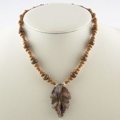 "I love the character of Rhyolite with its stylish mix of greens and soft rich browns. I've mixed in some more neutral browns from chocolate Agate and Wooden Jasper to let the Rhyolite take center stage. The necklace length is 19\" with a 2\" natural carved leaf. You can't get any more organic than these natural stone beads. I can add matching earrings for another $8. I use Sterling French wires. Each of my beaded pieces is a unique one-of-a-kind creation with it's own special characer setting it apart from any other beaded piece.  My standard minimum shipping method to U.S. & Canada is USPS Priority with delivery confrimation. Everywhere else is standard parcel service, non-insured. If you need faster delivery than Priority just let me know BEFORE you pay so I can add in the corrected shi Nature-inspired Brown Beaded Necklace, Nature-inspired Brown Necklaces With Natural Variations, Nature-inspired Brown Necklace With Natural Variations, Rustic Brown Healing Necklace, Brown Gemstone Beads Nature-inspired Necklace, Brown Jasper Gemstone Bead Necklace, Brown Jasper Gemstone Bead Necklaces, Brown Jasper Gemstone Beaded Necklace, Nature-inspired Brown Gemstone Bead Necklace