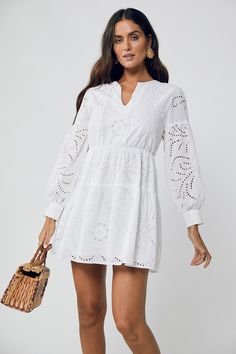 Dreamy summer staple. The June Ballon Sleeve Mini Dress screams summer vacay. Our White Broderie Anglaise 100% Cotton is light and effortless. With a lightly elasticated waist, loose fitting cuff sleeves this Aline Mini is featuring a V neck is fully lined and perfect for casual dinner on those balmy nights relaxing o Chic V-neck Maxi Dress With Hollow Out, Casual Crochet Dress With Pointelle Knit And V-neck, Chic V-neck Crochet Dress For Day Out, Spring V-neck Hollow Out Midi Dress, Spring Hollow Out V-neck Midi Dress, Casual V-neck Crochet Dress For Day Out, Spring V-neck Maxi Dress With Hollow Out Details, V-neck Hollow Out Maxi Dress For Spring, Spring Hollow Out V-neck Maxi Dress