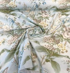 the fabric has flowers on it and is blue