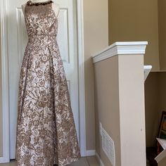 a dress on display in front of a white door with a brown and tan pattern