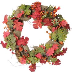 a wreath with red and green leaves on it, surrounded by pine cones and acorns