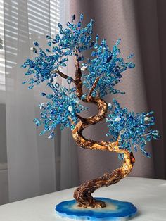 a bonsai tree with blue and gold leaves