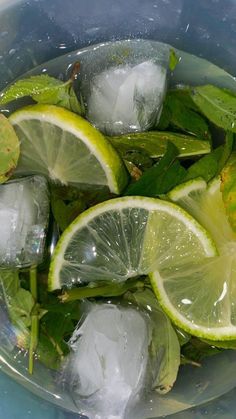 limes and ice in a bowl with water