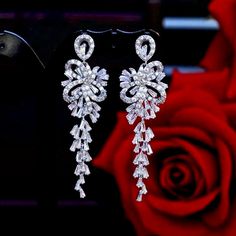 A delightfully unique pair of bridal earrings with an incredible sparkle! Adorned with flawlessly faceted cubic zirconia that capture the light in a dazzling array of sparkles, the earrings are rhodium plated for a bright finish which enhances the intricate detailing and conveys a modern take on old elegance. Length: 60mm (approx. 2.3"). Width: 18mm (approx. 0.7"). Weight: 11g. Available in Silver and Rose Gold finishes. To make your choice select your preferred finish from the dropdown menu to Luxury Festive Cubic Zirconia Chandelier Earrings, Cubic Zirconia Bridal Earrings, Silver Bridal Earrings, Modern Jewellery Design, Silver Wedding Jewelry, Badass Style, Bridal Event, Wedding Accessories Jewelry, Silver Rose Gold