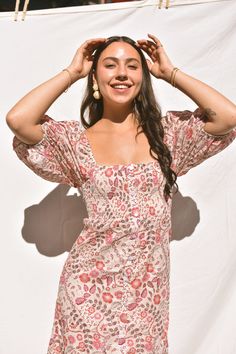 Sometimes you just need that everyday dress that's equal parts comfortable and cute. Our Dahlia Floral Maxi dress is cut from cotton pink, purple and mocha floral/paisley print fabric. Classic column dress silhouette with a button-down front, soft blouson sleeves and smocked back. You can wear the sleeves on or off the shoulders to give you a variety of different looks. This is the perfect bohemian dream dress! Bohemian Paisley Print Daywear Dresses, Chic Short Sleeve Dresses With Paisley Print, Spring Pink Paisley Print Mini Dress, Spring Pink Paisley Mini Dress, Pink Ditsy Floral Print Dress With Puff Sleeves, Pink Puff Sleeve Dress With Ditsy Floral Print, Pink Bohemian Puff Sleeve Dresses, Fitted Boho Print Mini Dress For Day Out, Pink Square Neck Printed Dress