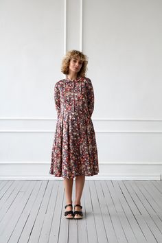 "Midi-length dress made in a soft and lightweight tana lawn cotton fabric. Fitted bodice, with a rounded peter pan collar, button closure down the front. Pleats in to waist. Bracelet-length sleeves with double-buttoned cuffs. - Handmade in our studio from 100% Liberty Tana Lawn cotton - Fitted bodice, half-length buttons closure, pleats into waist - Peter pan collar - Bracelet-length sleeves - Buttons opening at the front - Pleated skirt with side pockets FABRIC&CARE Fabric of dress behaves Long Sleeve Cotton Dress, Long Sleeve Print Dress, Liberty Of London, Midi Length Dress, Pan Collar, Peter Pan Collar, Fitted Bodice, Skater Dress, Cotton Dress