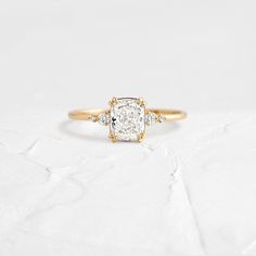 an engagement ring with a cushion cut diamond