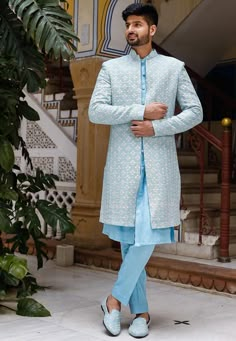 Faux Georgette Sherwani in Light Blue. This Readymade attire with Satin Lining is Enhanced with Pockets, Resham, Sequins Work. Crafted in Chinese Collar Neck and Full Sleeve. Available with an Art Silk Aligarhi Pant in Light Blue and an Art Silk Inner Kurta in Light Blue. Do note: Footwear shown in the image is for presentation purposes only. Half to one inch may vary in measurement. (Slight variation in actual color vs. image is possible) We sell all kinds of menswear. Mens Kurta | Mens Kurta P Engagement Outfits Indian, Indo Western Dress For Men, Indian Wedding Suits Men, Wedding Clothes For Men, Blue Sherwani, Indian Wedding Clothes For Men, Indian Jackets, Indian Wedding Clothes, Wedding Kurta For Men