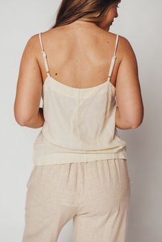 Whether you're on your way to sun-kissed beaches, picking up some things at the farmer's market, or stopping by your favorite coffee shop, you'll want to be wearing the Mello Tank. This is the easiest top we've curated this season -- it's breezy, chic, and completely feminine without any frills. Pair with denim, linen, or a slinky satin midi skirt. FIT: Runs true to size. MATERIAL: 55% Linen, 45% Rayon. GARMENT DETAILS: Lightweight camisole tank with square neckline, adjustable spaghetti straps, and relaxed fit. No lining. SIZE GUIDE: XS (0-2) / S (2-4) / M (6-8) / L (10-12) / XL (14-16) MODEL DETAILS: MISSES Mackenzie - Size S Heather - Size S Bust 34" 34" Waist 27.5" 27.5" Hips 40.5" 37.5" Height 5'7" 5'7" White Summer Vacation Camisole, Summer Beach Tank Top With Adjustable Straps, Summer Vacation Tank Top With Adjustable Straps, Summer Tank Top With Adjustable Straps For Beach, Summer Tank Top With Adjustable Straps For Vacation, Summer Camisole With Adjustable Straps, Summer Spaghetti Strap Tank Top For Vacation, Summer Spaghetti Straps Tank Top For Vacation, Spring Tank Top With Adjustable Straps