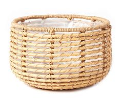 a woven basket with glass inside on a white background for use as a planter