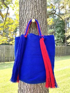 These beautiful, one-of-a-kind, 100% handmade top handle bag has been carefully crocheted by women from the Wayuu tribe in La Guajira, Colombia.This beautiful Wayuu braided bag is carefully crafted using a double thread technique for the body. Approximate dimensions:Height: 11-12 inchesWidth: 13 inchesDepth: 4 inchesEach piece represents approximately 1 week of work for a single artisan.**Listing is for 1 Wayuu bag only.**Please choose color in the drop down options. Blue Handwoven Top Handle Bag, Handmade Top Handle Bucket Bag, Blue Handwoven Bag As A Gift, Large Handmade Shoulder Bag For Shopping, Handwoven Blue Square Bag, Blue Square Handwoven Shoulder Bag, Blue Handwoven Square Bag, Blue Square Handwoven Bag, Large Handmade Shoulder Bag For Everyday