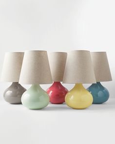 three different colored lamps sitting next to each other