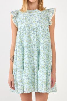 This beautiful dress is perfect for any special occasion. With a floral print and delicate embroidery, this dress is sure to turn heads. The back spaghetti tie allows you to adjust the fit, while the side pockets provide a touch of functionality. Whether you're attending a wedding or a birthday party, this dress is sure to make you feel like the belle of the ball. Floral with embroidery Back spaghetti tie Side pockets Lining Hand wash cold Do not bleach Do not tumble dry Iron low Shell: 100% Cot Tiered Printed Dress For Garden Party, Feminine Blue Dresses With Floral Embroidery, Feminine Green Dresses With Lace Trim, Feminine Green Dress With Lace Trim, Feminine Tiered Cotton Dresses, Light Blue Floral Embroidery Dress For Summer, Light Blue Floral Embroidered Summer Dresses, Light Blue Ditsy Floral Print Short Sleeve Dress, Light Blue Floral Embroidered Dress For Summer