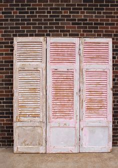 an old wooden door with shutters on the outside