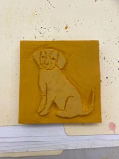 a yellow dog stamp sitting on top of a piece of paper