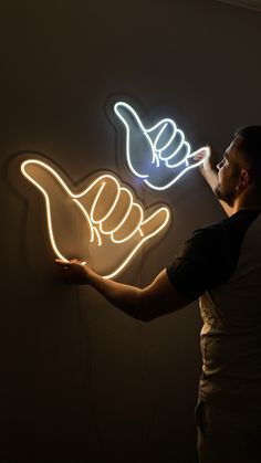 a man standing in front of a neon sign