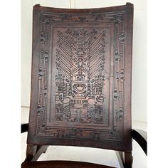 a wooden chair with an intricate design on the back