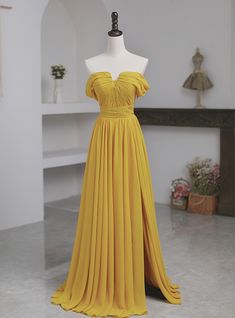 a yellow dress on display in a room