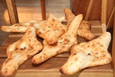 several pieces of pizza sitting on top of a wooden table