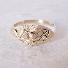 This vintage-inspired floral ring is a row of dainty flowers wrapped around your fingers. Handmade and polished, it is available in solid 8K and 14K gold. This item is engravable with text or monogram of your choice at no extra cost. The initals are engraved onto the ring and embedded in the 3D model for a flawless embossed finish. It is also possible to add a diamond or birthstone or diamond to this ring at an additional fee. Please inquire for details. A few notes about our gold: - Though we d Luxury Brilliant Cut Engraved Ring, Luxury Gold Signet Ring With Diamond Accents, Luxury Wedding Signet Ring With Single Diamond, Luxury Vintage Signet Ring With Diamond Accents, Luxury Art Deco Signet Ring As A Gift, Luxury Gold Signet Ring With Halo Setting, Luxury Antique Engraved Ring For Commemoration, Luxury Vintage Engraved Ring With Hallmarks, Luxury Art Deco Signet Ring For Gift