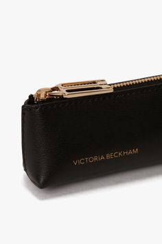 With its elegant rectangular silhouette, the B Frame Long Pouch in Black has a modern refinement. Crafted in Italy from tactile grained leather, it is lined in hard-wearing canvas and adorned by a B-engraved zip puller. A Victoria Beckham stamp and serial number complete the look. Victoria Beckham Exclusive Pencil Case In Black Leather  - Size ONE SIZE UK Luxury Pencil Case, Elegant Formal Rectangular Pouch, Rectangular Leather Pouch For Formal Occasions, Elegant Black Rectangular Pouch, Formal Rectangular Wallet, Elegant Pouch With Interior Card Slots, Luxury Rectangular Office Pouch, Black Leather Rectangular Pencil Case, Modern Rectangular Bag With Pen Slots