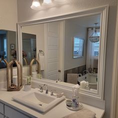 Bathroom Mirror White Frame, Trimmed Bathroom Mirror, Frameless Bathroom Mirror Ideas, Frames Around Bathroom Mirrors, White Framed Bathroom Mirror, Frame Existing Bathroom Mirror, Wide Mirror Bathroom, Bathroom Mirror Trim Ideas, Mirror Trim Bathroom Diy Frame