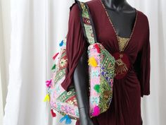 Patchwork, embroidery and sequins women's tote bag. A colourful ethnic shoulder bag from India for women. Unique, classy day or evening hand bag. Take patches of colourful cloth. Add interesting embroidery of sequins and stones and beads. Add some more colourful stitches with contrasting colour thread. Mix and match the patches and hand stitch them with a colourful beading. Add handles. Voila! You have a tote bag that is so unique that there just cannot be another one such, anywhere in the unive Rectangular Multicolor Sequined Shoulder Bag, Everyday Shoulder Bag With Mirror Work, Bohemian Embellished Bag For Festive Occasions, Bollywood Style Shoulder Bag With Zari Work, Bohemian Embellished Shoulder Bag For Festive Occasions, Bollywood Style Shoulder Bag For Festivals, Multicolor Embroidery Hobo Bag For Festivals, Bohemian Multicolor Bags With Zari Work, Embellished Multicolor Tote Shoulder Bag