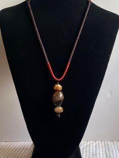 This antique necklace is a beautiful piece of jewelry that is sure to catch the eye of anyone who sees it. The necklace is made of Dzi agate beads. It is estimated to be around 1850-1899 years old, making it a truly ancient piece. The necklace is in its original state with Good patina. It is perfect for anyone who loves to collect antiques.It is  considered as bring good luck and absorb all the negative energy from your bodies. This necklace is a true treasure and would make a great addition to any collection. Sold As It Is. Amulet Necklaces With Large Oval Beads, Elegant Agate Beaded Necklace With Polished Beads, Vintage Gemstone Beads Jewelry For Meditation, Elegant Hand-strung Onyx Necklaces, Elegant Hand-strung Agate Necklace, Elegant Hand-strung Onyx Necklace, Elegant Onyx Hand-strung Necklaces, Elegant Onyx Hand-strung Necklace, Hand-strung Amulet Necklaces With Oval Beads