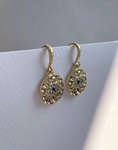 Introducing the Evil Eye Earrings, a mesmerising blend of protection and elegance, crafted from high-quality brass and plated with lustrous 18K gold. These greek earrings feature a distinctive hammered texture that adds a touch of artisanal charm, making each pair unique. The focal point of these nazar earrings is the intricate evil eye pattern, formed by sparkling cubic zirconia crystals. The crystals are meticulously set to create a captivating and protective symbol, known for warding off nega Yellow Gold Earrings With Diamond Eyes For Anniversary, 14k Yellow Gold Earrings With Diamond Eyes, Yellow Gold Diamond Eyes Earrings For Anniversary, Formal 14k Gold Earrings With Diamond Eyes, Anniversary Yellow Gold Earrings With Diamond Eyes, 14k Gold Halo Design Drop Earrings, Fine Jewelry Diamond Eyes Earrings For Anniversary, Gold Diamond Earrings With Diamond Eyes For Anniversary, Gold Dangle Hoop Earrings With Halo Design