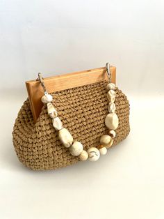 a straw purse with beads hanging from it