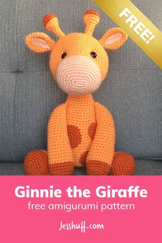 a crocheted giraffe stuffed animal sitting on top of a blue couch