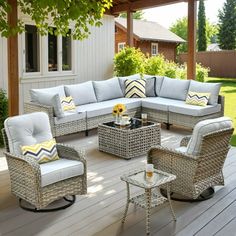 an outdoor patio with wicker furniture and sunflowers