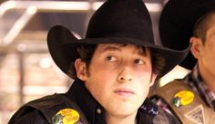 two young men wearing cowboy hats and vests