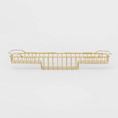 a gold metal wire basket on a white background