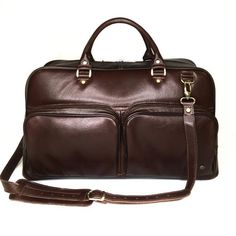 The leather travel bag is perfect for business or weekend trips. Suitable for men and women. Handmade, original design. Very light weight.Dimensions:* Height: 29 cm (11.42 inches)* Length: 50 cm (19.69 inches)*  Width: 20 cm (7.87 inches)* Strap Drop length: max 130 cm (51.18 inches)Details:* One main part* Removable adjustable shoulder strap* Double leather handle * Two outside zipper pockets in the front of the bag* Zipper pocket inside* Two slip pockets insideLeather travel bag with pockets D Classic Brown Duffle Bag For Trip, Classic Brown Weekender Bag For Trips, Brown Leather Travel Bag For Business Trips, Classic Brown Travel Bag With Luggage Sleeve, Brown Leather-lined Weekender Bag For Business Trips, Brown Business Weekender Bag With Luggage Sleeve, Brown Tote Travel Bag For Business Trips, Brown Satchel Duffle Bag For Business Trips, Brown Briefcase With Luggage Sleeve For Trips