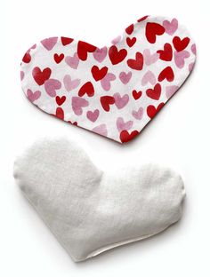 two pieces of cloth with hearts on them, one is white and the other is pink