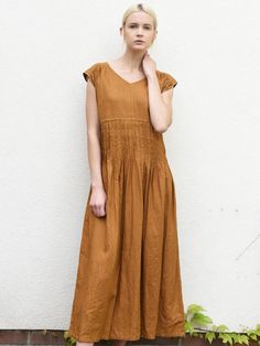 "Long linen dress with short sleeves and gorgeous pleats. The linen dress has vertical pleats on the front and back- around the midsection. Simple dress, but unique, romantic look. Comfortable and fresh design. Made in our workshop in Poland for you. Authentic Handmade. DETAILS: - 100% washed, softened, light linen. - Includes one linen dress - The images above show the turmeric and gray green colour - V neckline at the front - Bust darts to shape any figure - Shrinkage after the first wash up t Summer Linen Pleated Dress, Summer Brown Linen Daywear Dress, Summer Pleated Linen Dress, Casual Pleated Linen Dress For Summer, Casual Summer Dress With Pintucks, Casual Summer Dresses With Pintucks, Spring Linen Pleated Dress, Spring Pleated Linen Dress, Summer Linen Midi Dress With Ruched Details