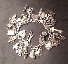 This piece is 100% sterling. There are 24 charms and one spring clasp. Every charm is articulated and most of them are moving charms. The man on the donkey charm has red enamel on his sombraro. All of the charms are linked to the bearcelet with a soldered jump ring each. There are 2 charms that are missing their parts, the piano 'lid' and the meatlocker door. Buyers are welcome to write with any questions and I am happy to send as many pictures as you need.  New York- 1921 -1959.  Thanks for looking. Vintage Sterling Silver Charm Bracelet, Silver Charms For Bracelets, Charming Bracelet, Artsy Jewelry, Vintage Sterling Silver Charms, Vintage Jewelry Crafts, Bus Terminal, Vintage Charm Bracelet, Sterling Silver Charm Bracelet