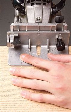 a person's hand is on top of a machine that has been placed in front of it