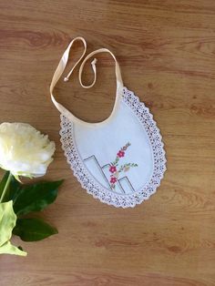 This is a pretty little handmade bib. Made from a vintage embroidered cotton doily with cotton crocheted edging . It has  cream binding ties and is backed with soft flannelette. Pretty and practical it would set off any little outfit for a special occasion, with a vintage feel . It measures approx 17 cm  long and 18 cm wide including lace trim. Please supervise baby while wearing this bib, not designed to be slept in. Ready to ship now. Thanks for looking . 😊 Cute Handmade Cotton Bib, Cute Handmade White Bib, Cute White Handmade Bib, Material Ideas, Handmade Bib, Vintage Doily, Kids Sewing, Girls Bib