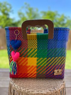 a colorful basket sitting on top of a wooden table