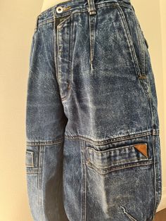 A gorgeous dark acid wash denim Bugle Boys with so many cool details!  So many pockets, seams and darts!  Tapered leg. 100% cotton Excellent condition! No size label.  Measurements: 20" waist, 12" rise, 33" inseam, 27" thigh, 7" leg opening. 90s Style Medium Wash Straight Leg Cargo Jeans, Casual Acid Wash Recycled Denim Jeans, Retro Denim Jeans With Pockets, Retro Denim Jeans, Retro Medium Wash Jeans With Pockets, Grunge Style Washed Denim Jeans, Faded Denim Cargo Jeans With Utility Style, Faded Denim Cargo Jeans In Utility Style, Vintage Style Medium Wash Denim Cargo Jeans